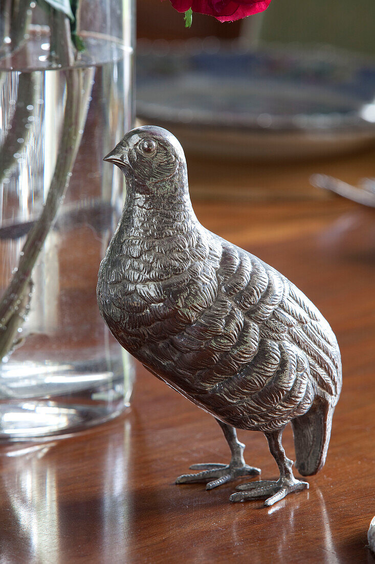 Silver hen ornament on polished wooden tabletop in East Sussex home, England, UK
