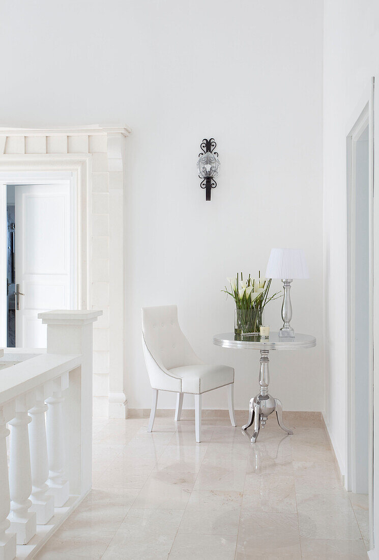 Side table and chair in white hallway landing, holiday villa, Republic of Turkey