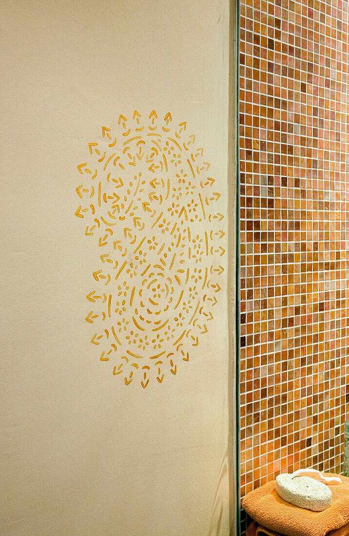 Bathroom detail with wall stencil and mosaic tiling London UK