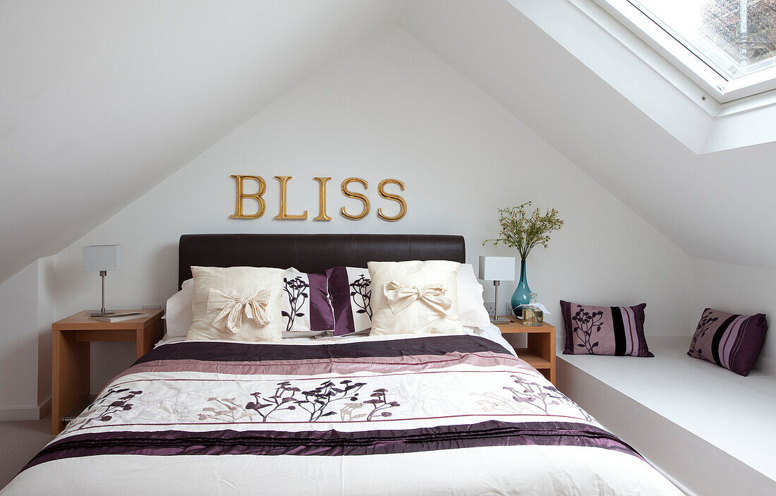 "Einzelner Schriftzug BLISS"" über einem Doppelbett im Dachgeschoss eines modernen Hauses in London, UK"""