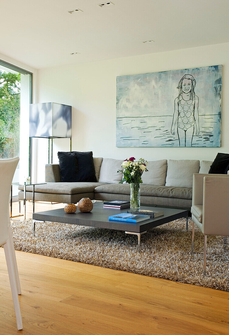 Low coffee table in seating are with artwork canvas in London home, England, UK