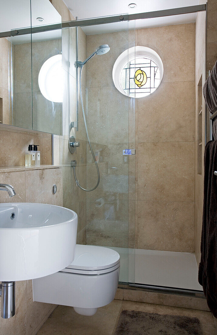 Shower room with circular window in London home, England, UK