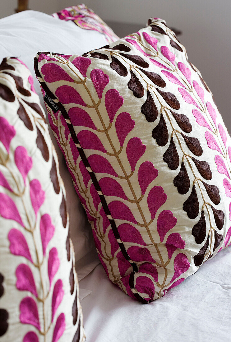 Pink and brown cushions on sofa in Wepham home Sussex UK