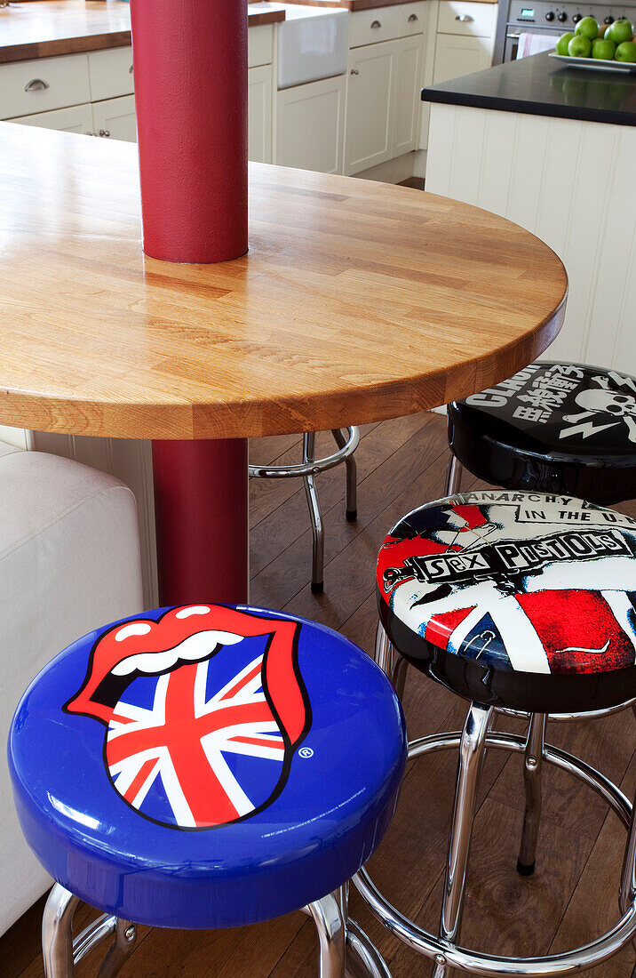 British punk upholstered bar stools at breakfast bar in Sussex kitchen UK