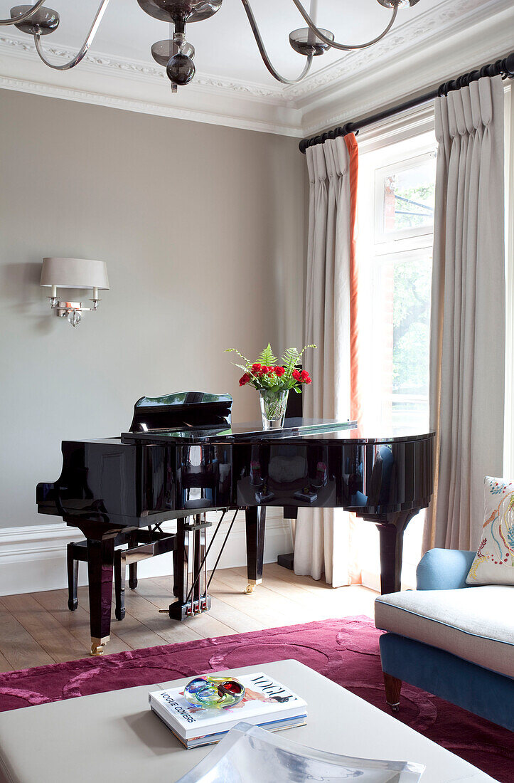 Black grand piano in living room of contemporary London home, UK
