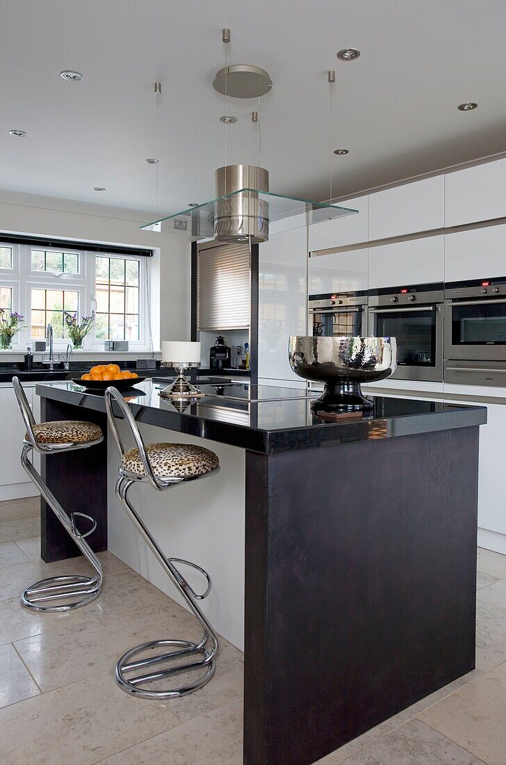 Animal print barstools at breakfast bar in kitchen of contemporary London townhouse, UK