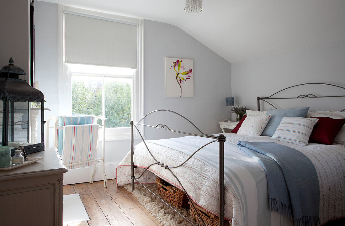 Antique lantern in light blue bedroom of contemporary London home, UK