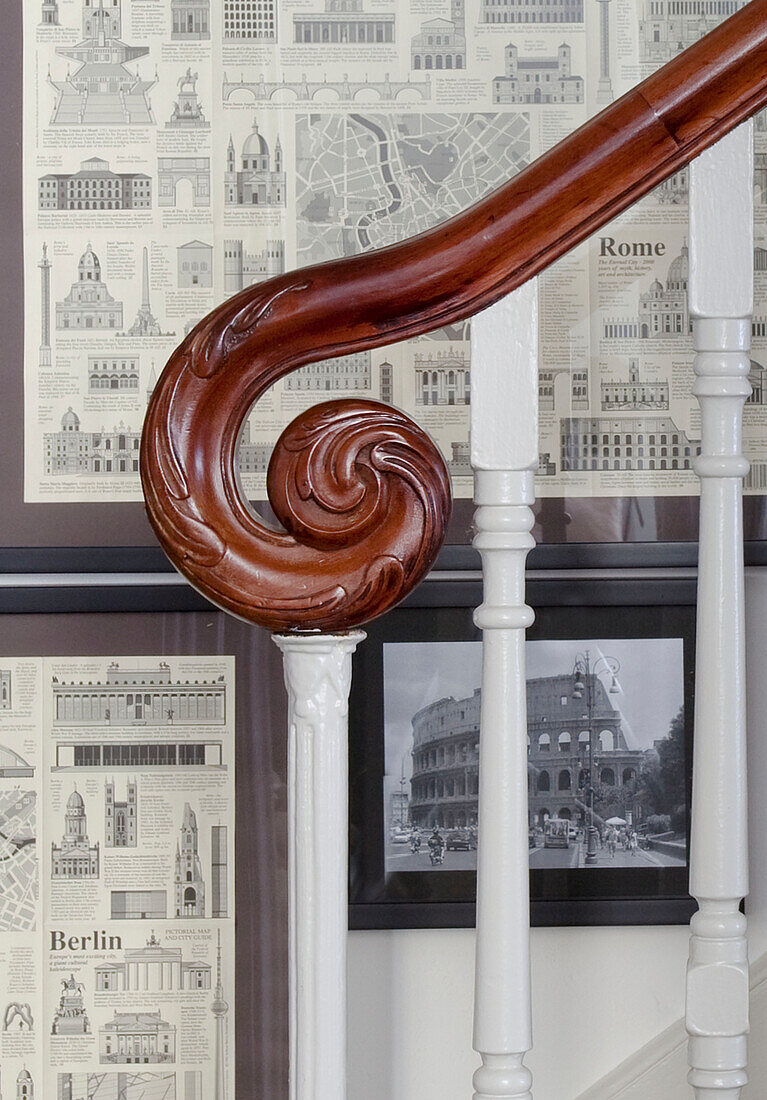Carved wooden handrail on staircase with architectural prints, Hove, East Sussex, England, UK