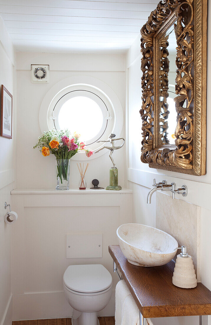 Bathroom with porthole on London houseboat