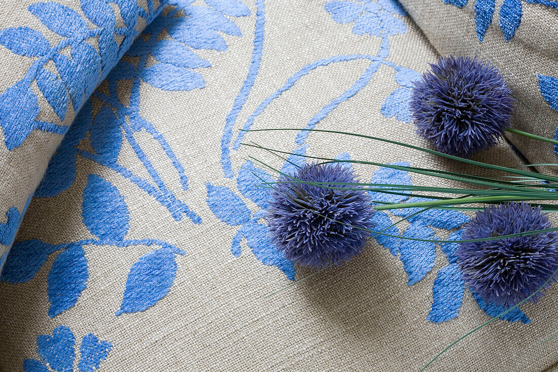 Cut flowers and blue floral patterned fabric in London home, England, UK