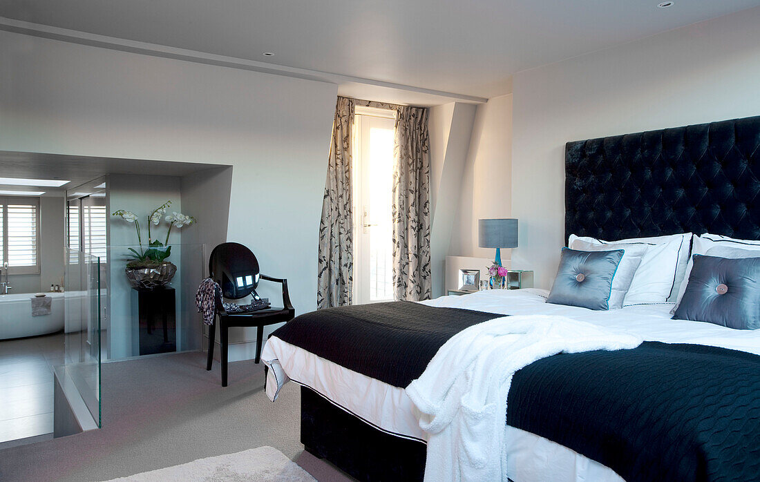 Split level master bedroom with en-suite bath in contemporary London home, UK