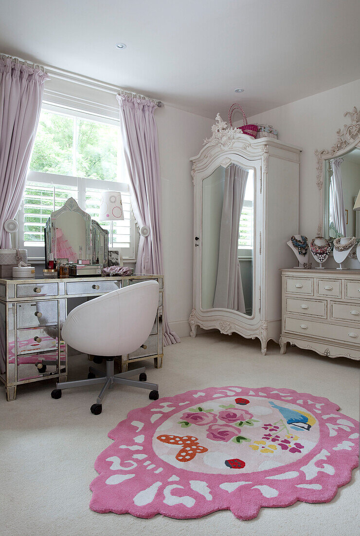 Mirrored dressing table at window in bedroom of London home, UK