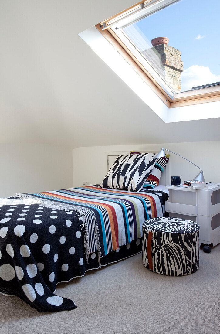 Funky bed cover in attic bedroom conversion, contemporary London home, UK