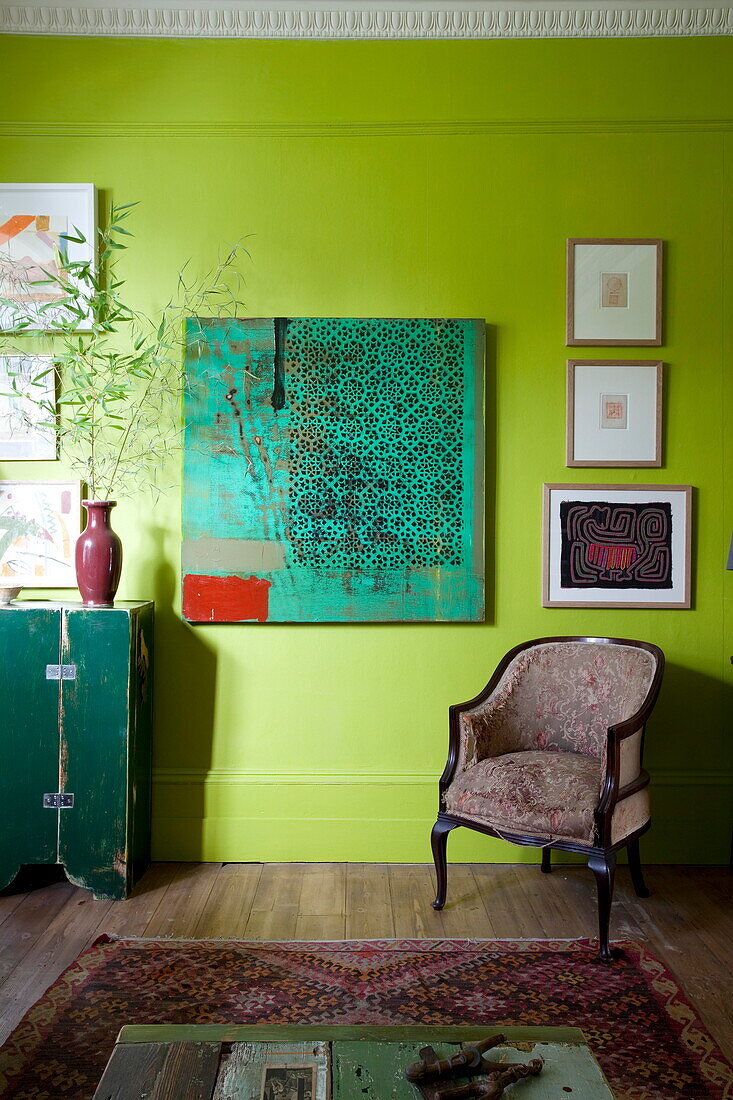 Artwork with armchair in living room of London home England UK