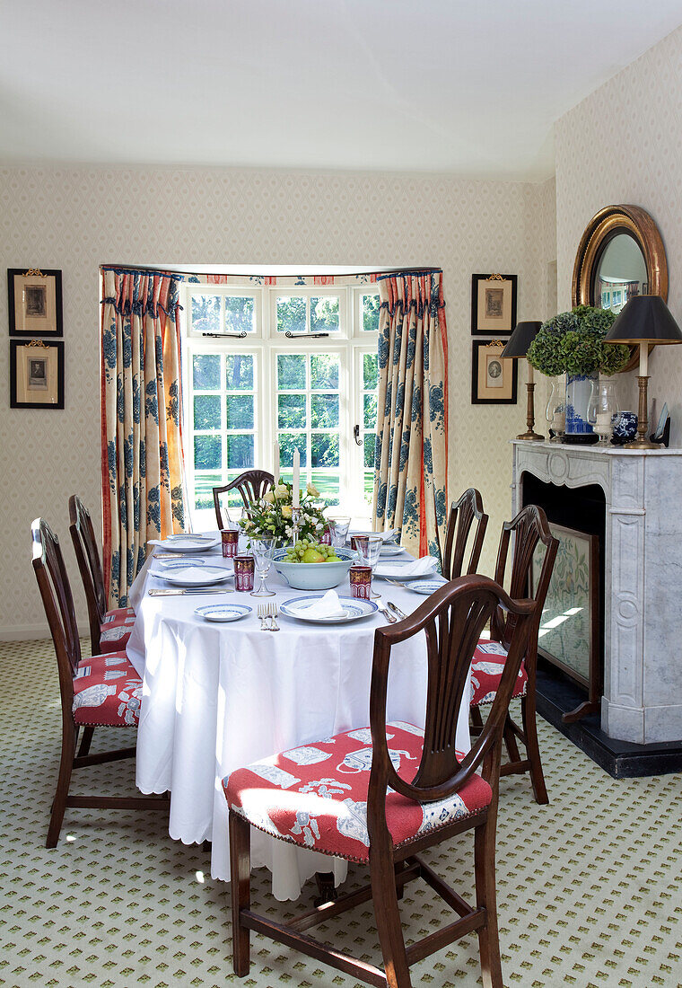 Dining table set for six with re-upholstered chairs in Sussex farmhouse, England, UK
