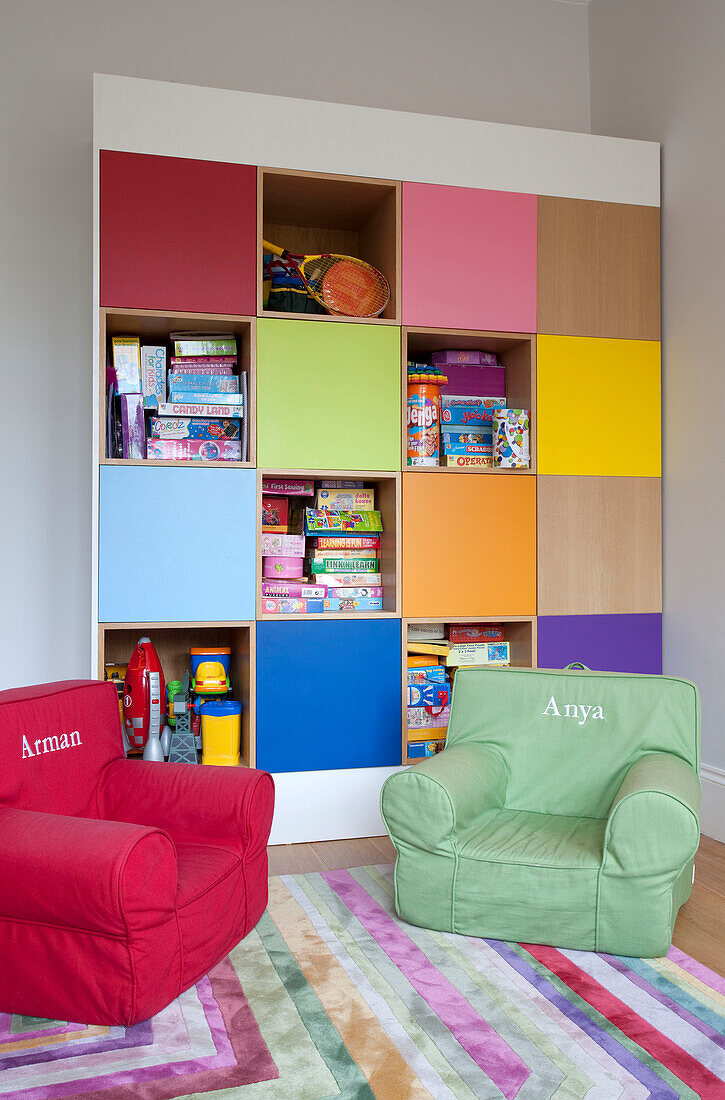 Brightly coloured storage shelving in contemporary London family home, UK