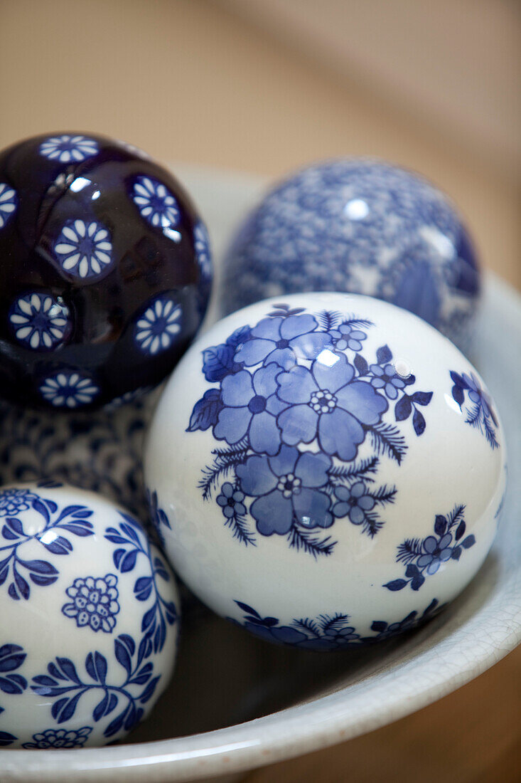 Blue and white floral ornamental balls in Kent cottage, England, UK