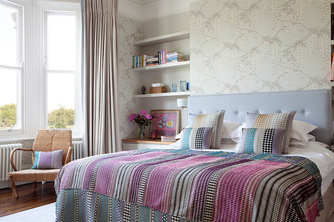 Double bed with recessed shelving in contemporary London townhouse, England, UK