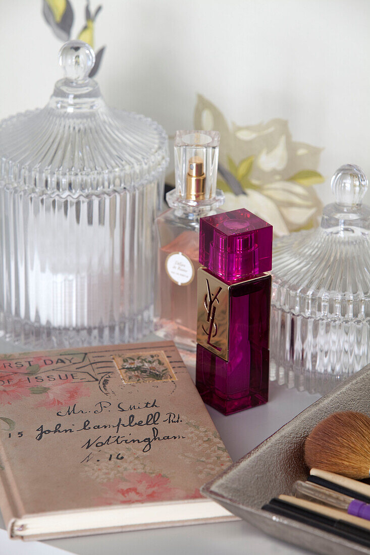 Perfume bottles and glassware with diary in London apartment, UK