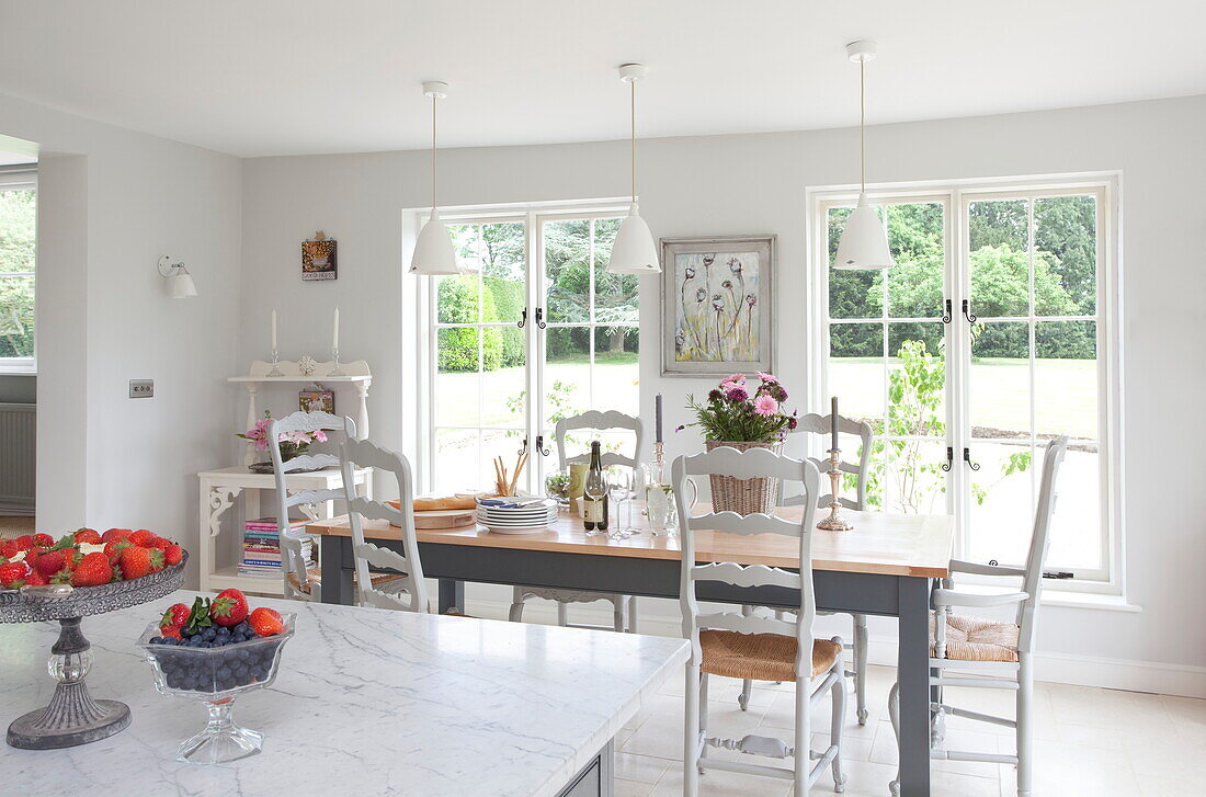 Open plan dining room and kitchen in Maidstone farmhouse, Kent, England, UK