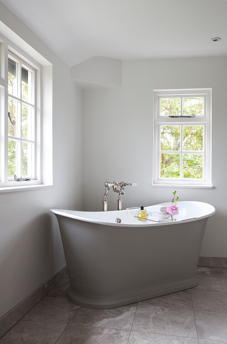 Freistehende Badewanne unter Fenster in Zimmerecke, Bauernhaus in Maidstone, Kent, England, UK