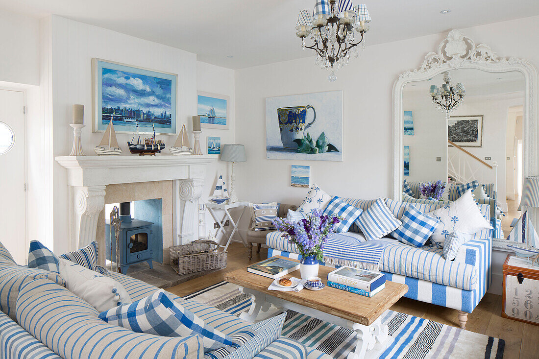 Striped sofas with checked cushions and large mirror in Dulwich home, London, England, UK