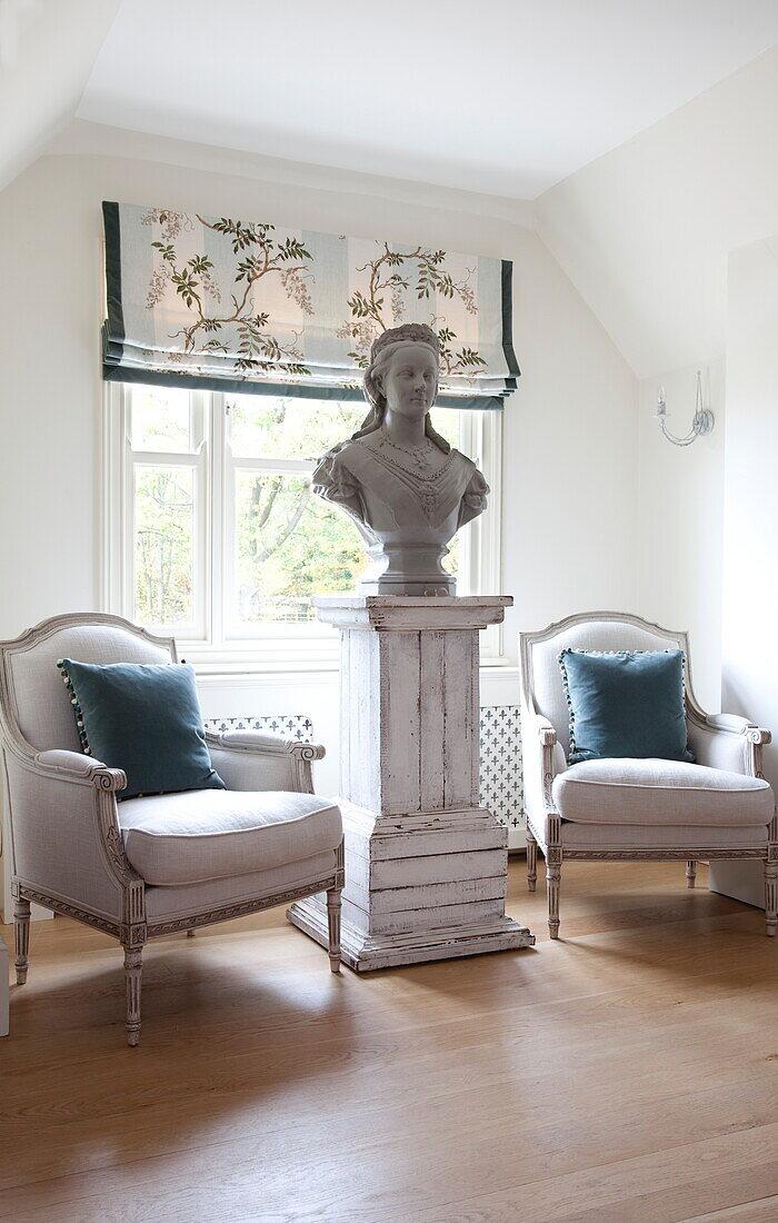Historic bust at window with a pair of antique chairs in Kent home, England, UK