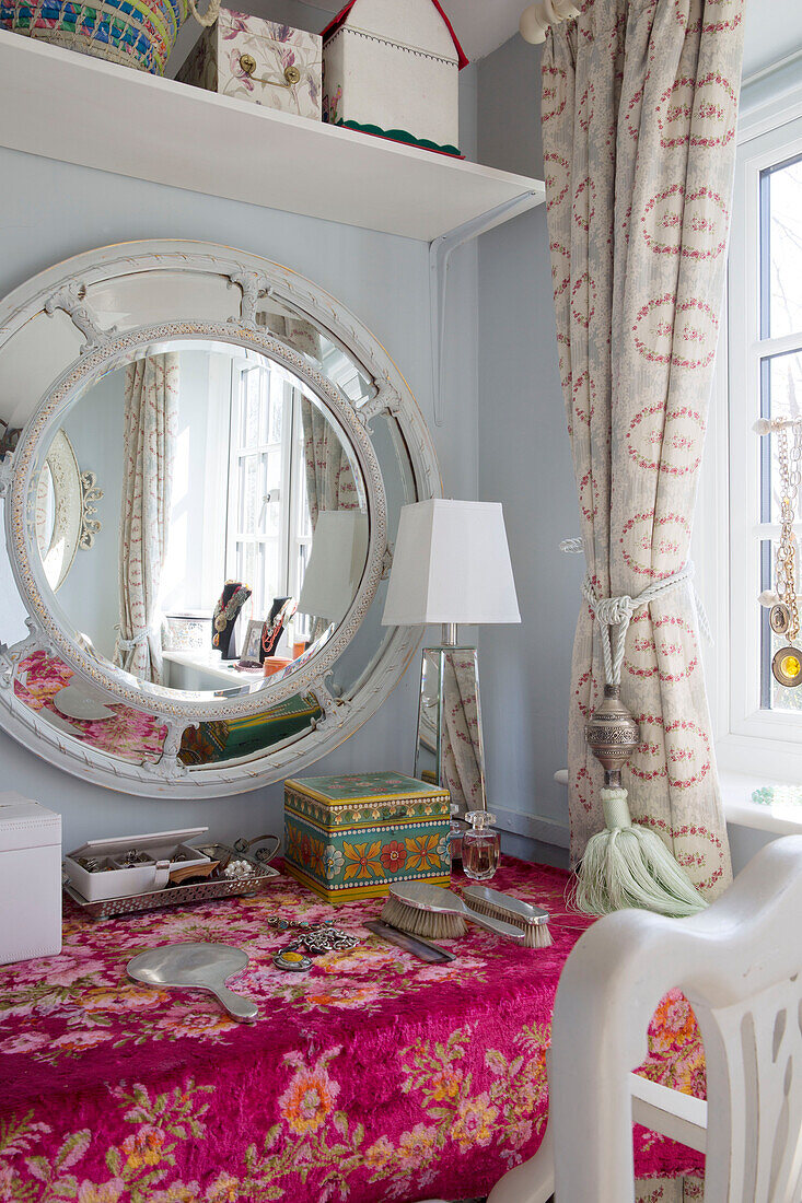 Convex mirror above dressing table in Sussex home England UK