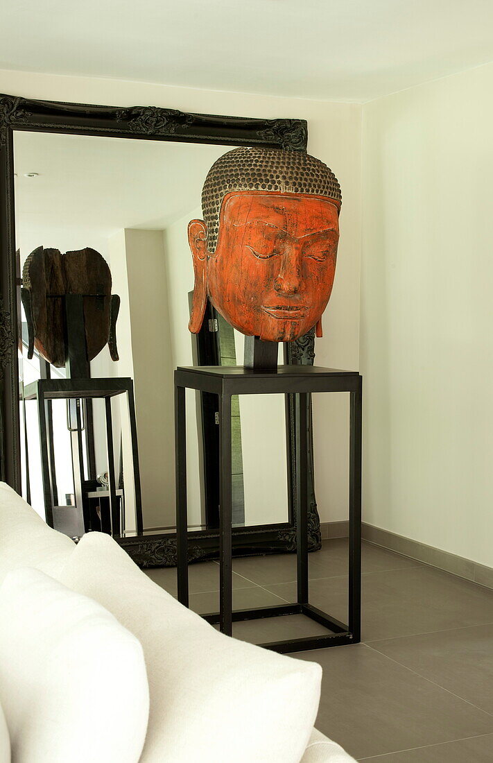 Buddha statue on plinth in contemporary new build, Kingston upon Thames, England, UK