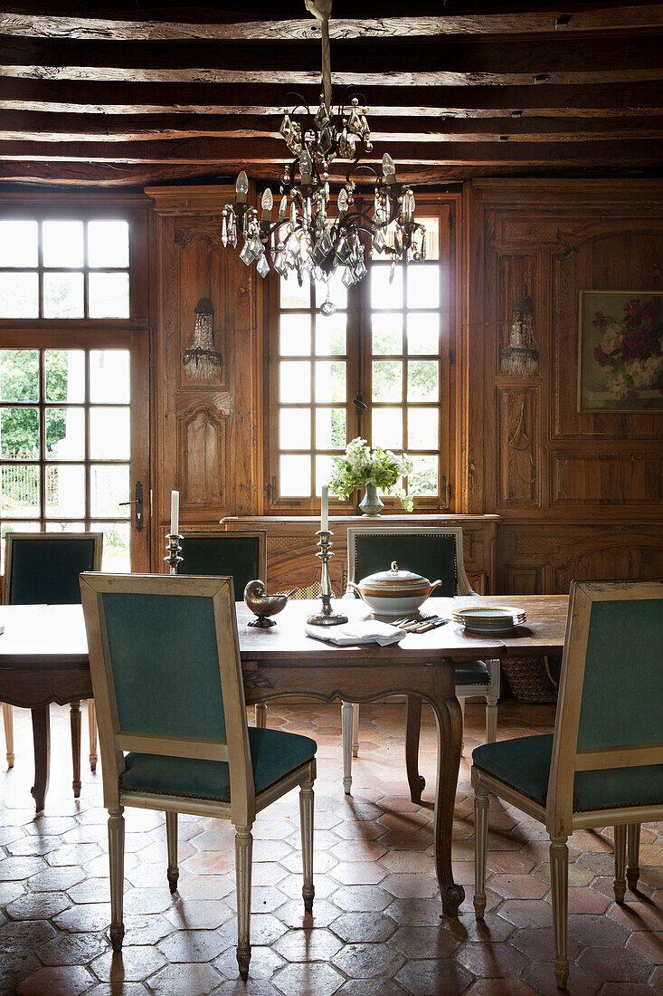 Glass chandelier above dining table in French farmhouse in the Loire, France, Europe