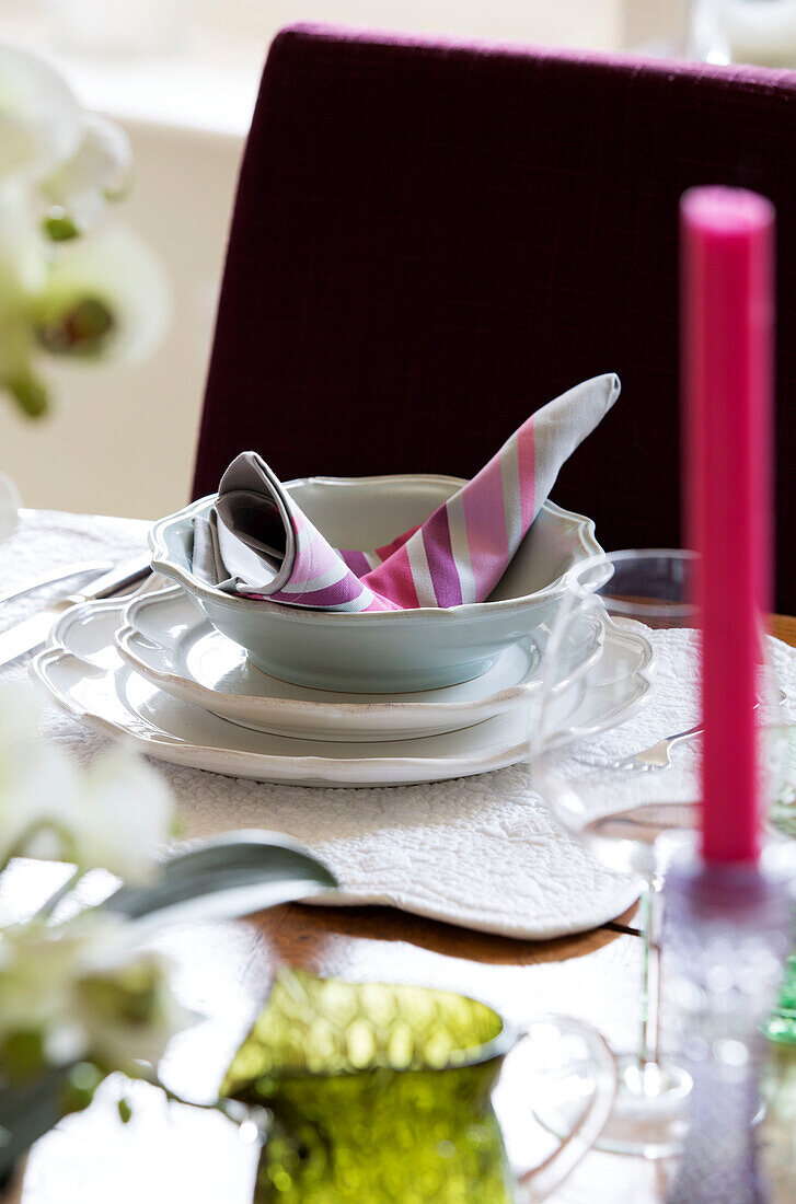 Place setting with napkin on dining table in London home England UK