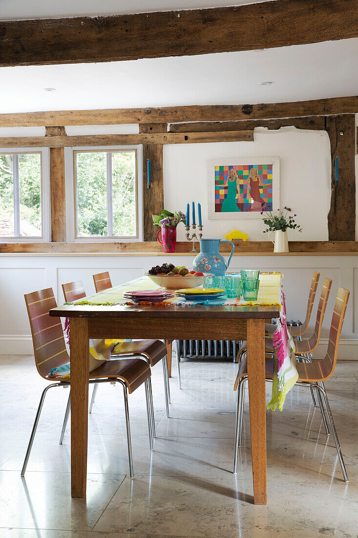 Wooden dining table and chairs in timber-framed Herefordshire home, England, UK