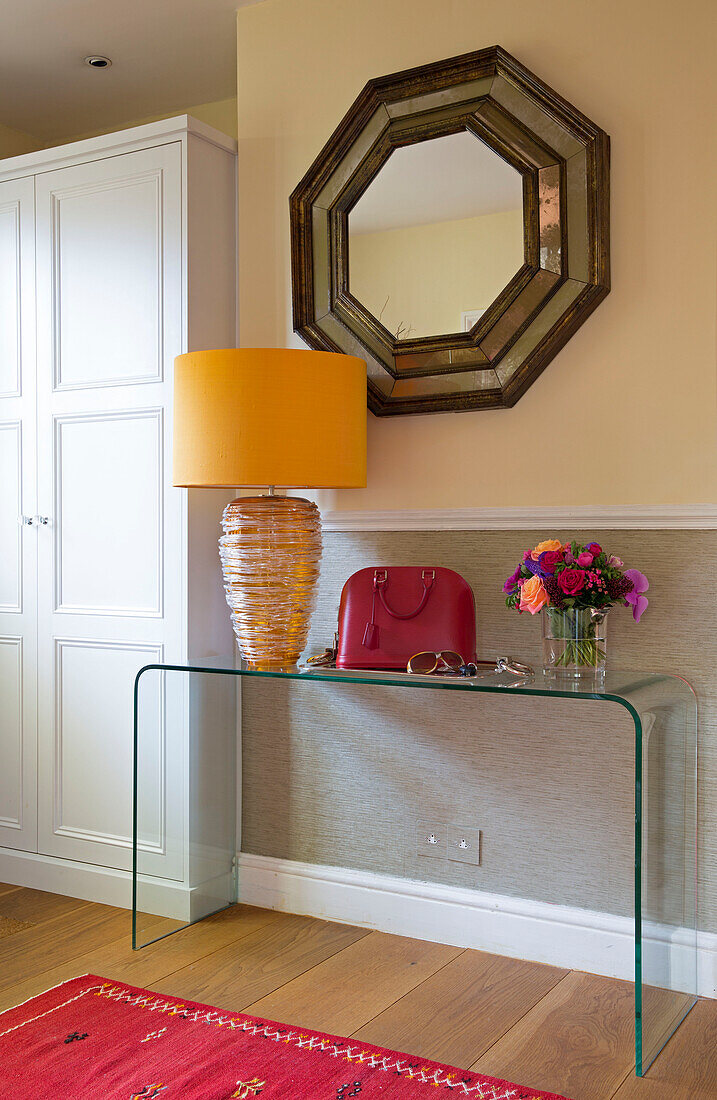 Vintage octagonal mirror above transparent console in hallway of Berkshire, home, England, UK