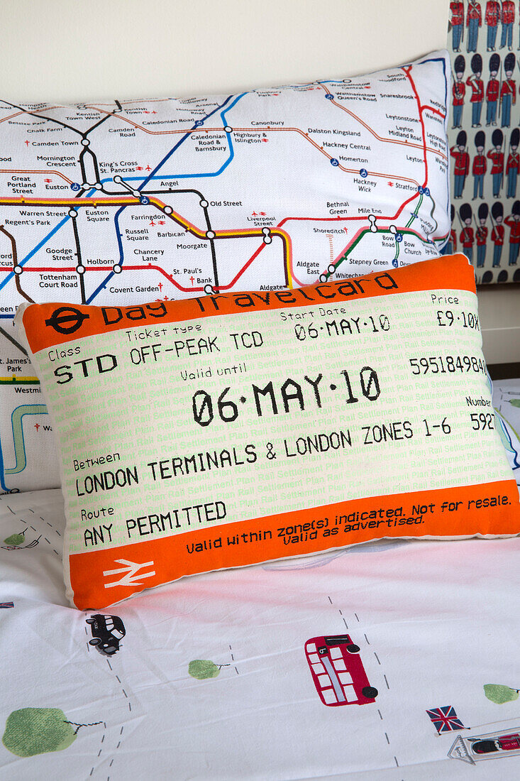 Travel ticket and tube map cushions in London family townhouse, England, UK