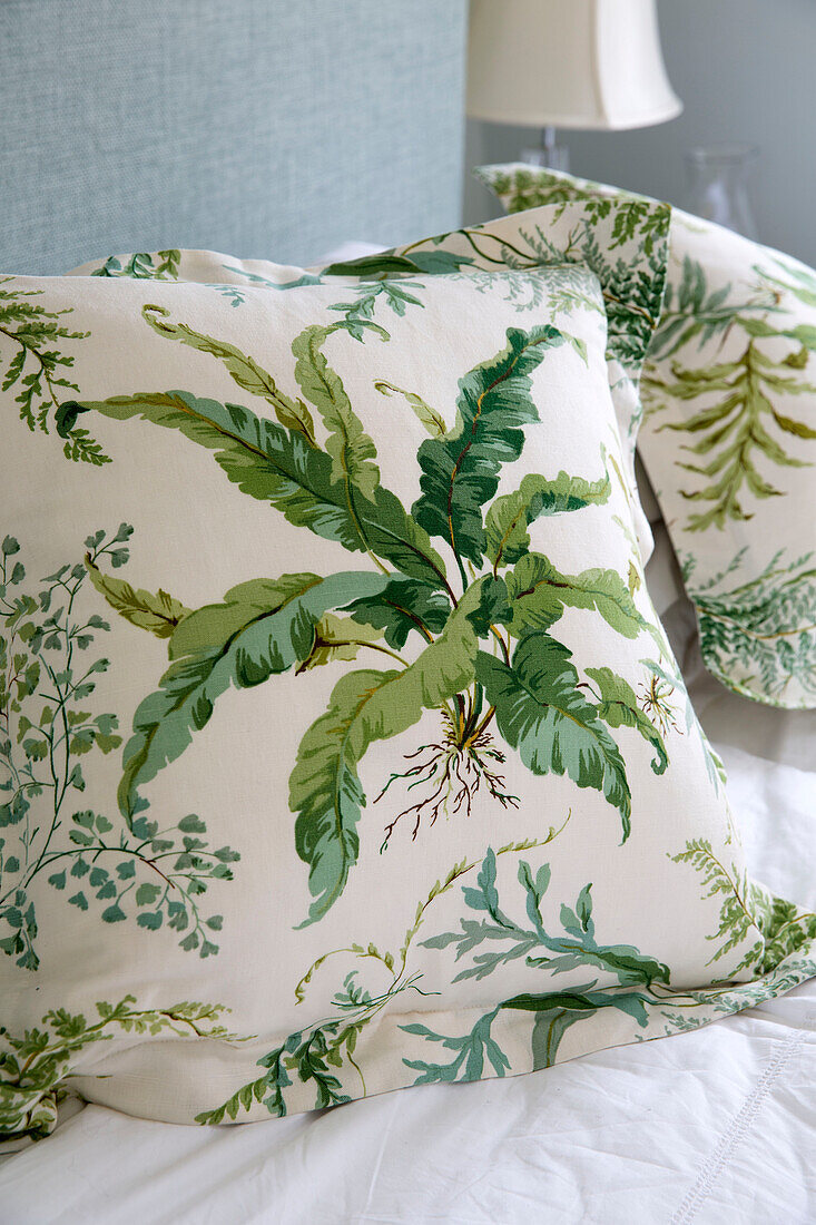 Leaf patterned cushion in bedroom of London townhouse, England, UK