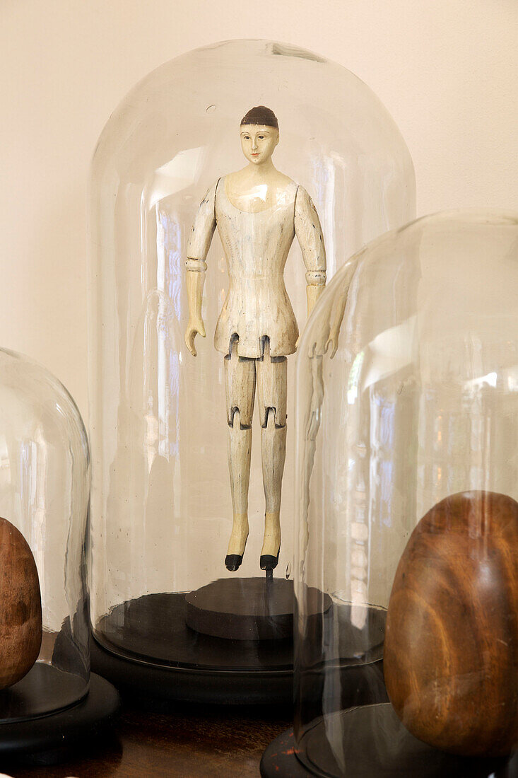 Figurine and carved wooden eggs under bell jars in Twickenham townhouse, Middlesex, England, UK