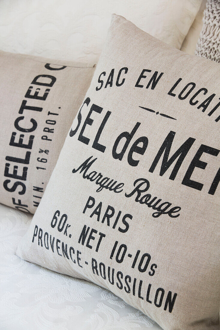 Printed lettering on hessian cushions in Twickenham townhouse, Middlesex, England, UK