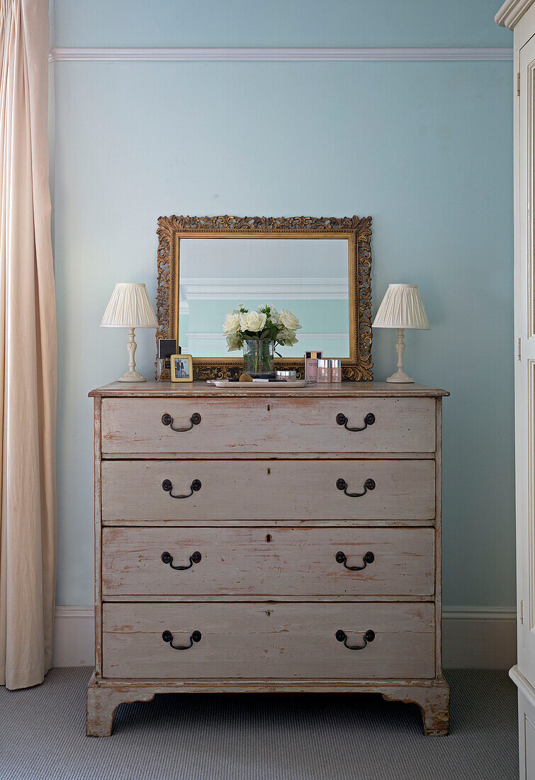 Pair of lamps in chest of drawers with mirror in light blue Shoreham by Sea bedroom   West Susses   England   UK