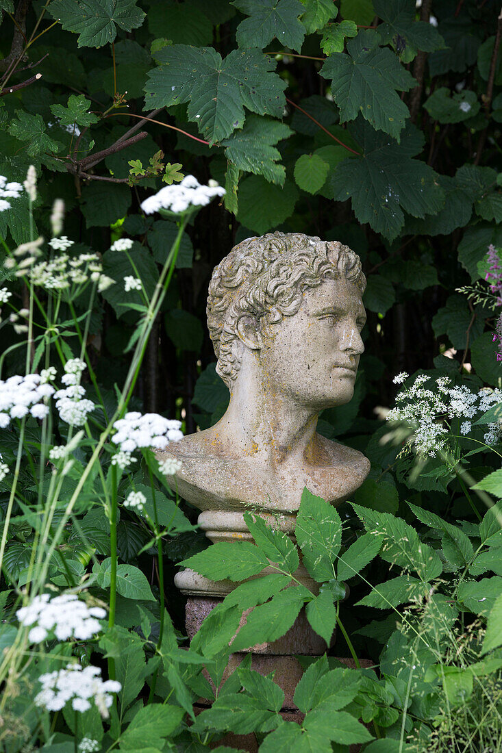 Carved stone bust in Presteigne garden Wales UK