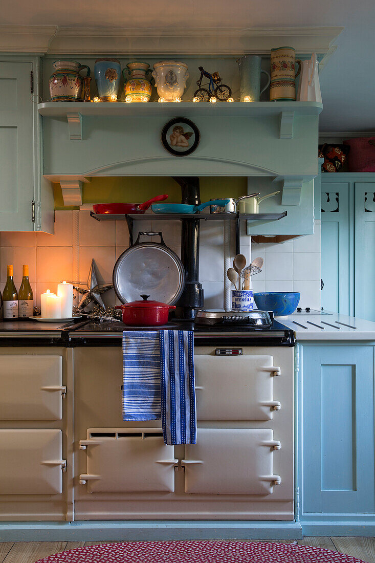 Lighting and homeware with range oven in Sussex kitchen  England  UK