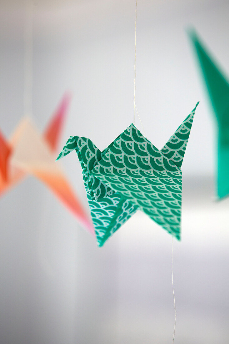 Green origami bird in London home,  England,  UK