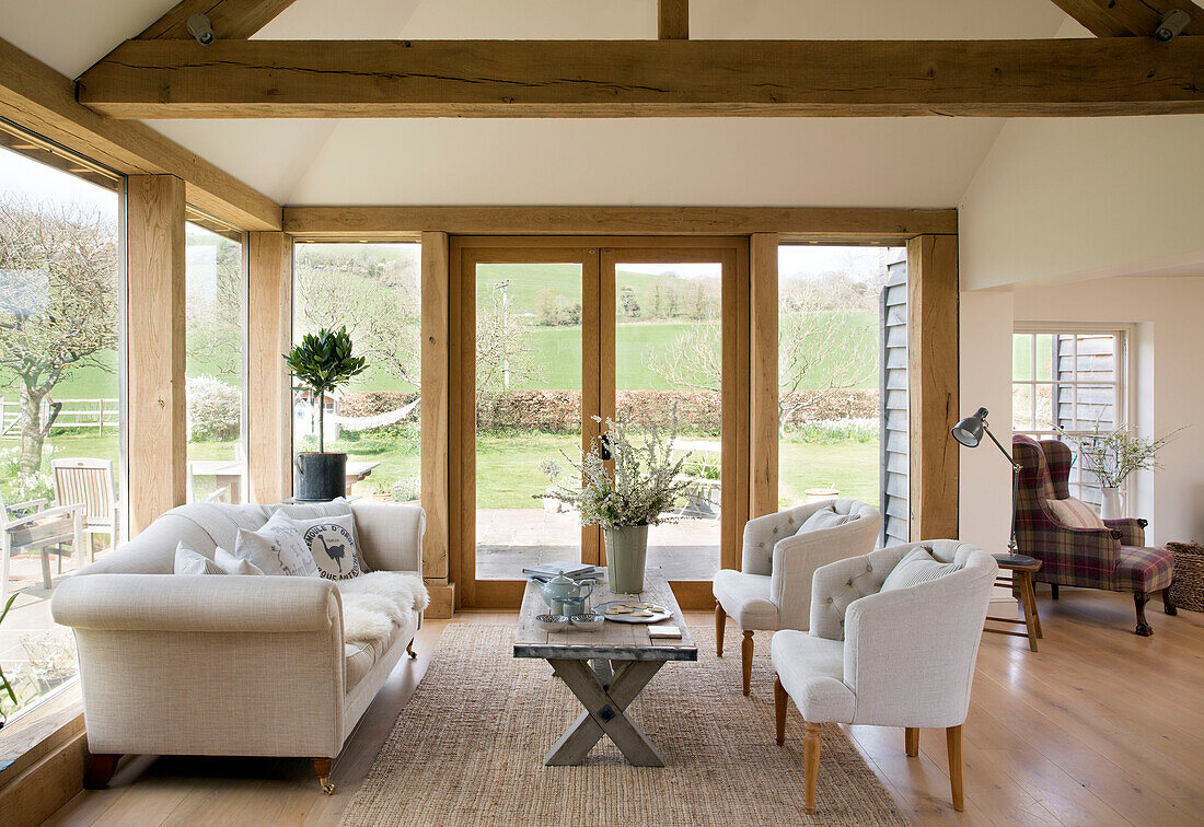 White sofa and matching chairs with coffee table in East Dean conservatory  West Sussex  UK