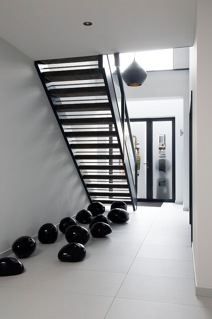 Zen styled entrance hallway and staircase in London home,  England,  UK