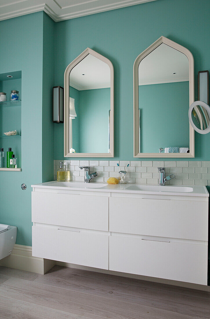 Double basins and mirrors with under sink storage in London home, England, UK