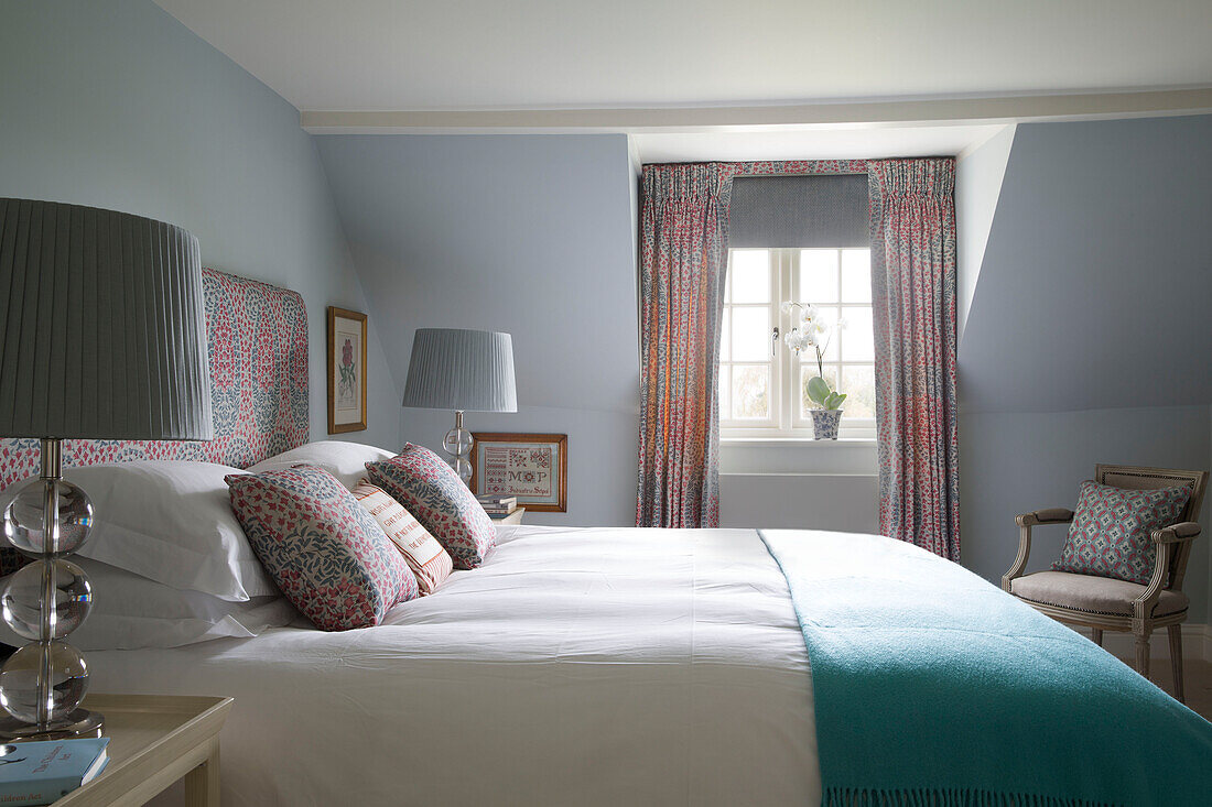 Sunlit bedroom with co-ordinated fabrics in Pewsey country house Wiltshire England UK 