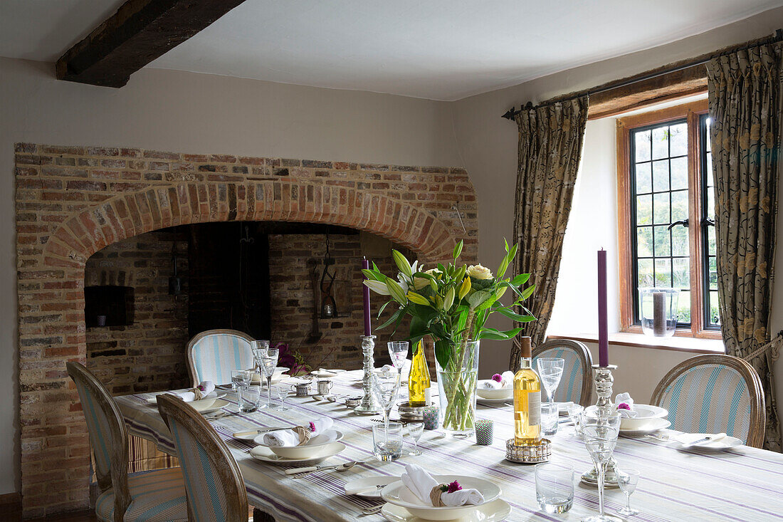 Cut liles in beamed Sussex dining room with exposed brick fireplace   England   UK