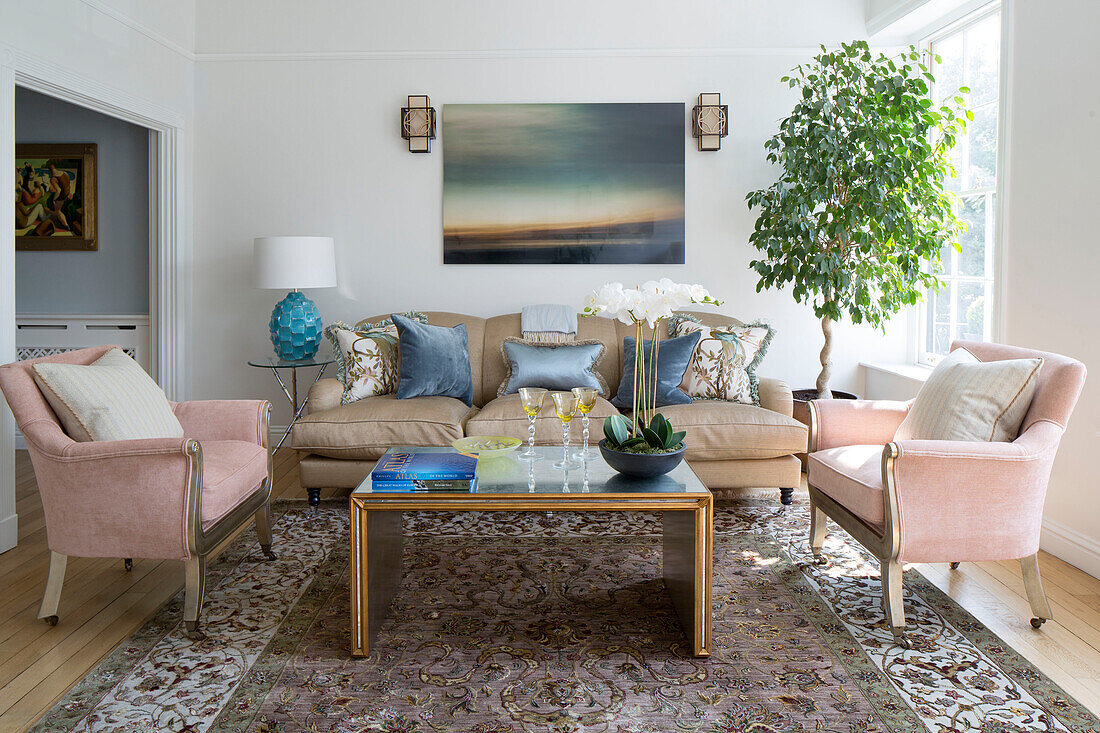 Leather sofa and artwork with patterned rug in living room of London townhouse England UK