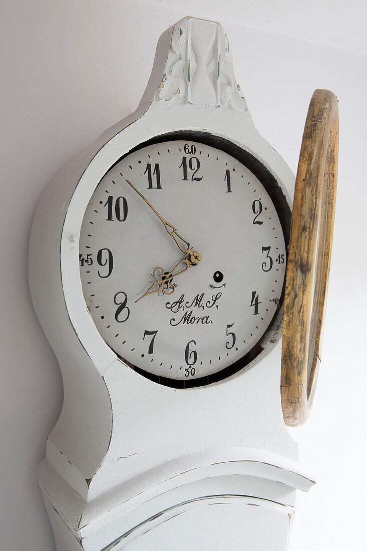 Winding the time on Gustavian clock Surrey England UK