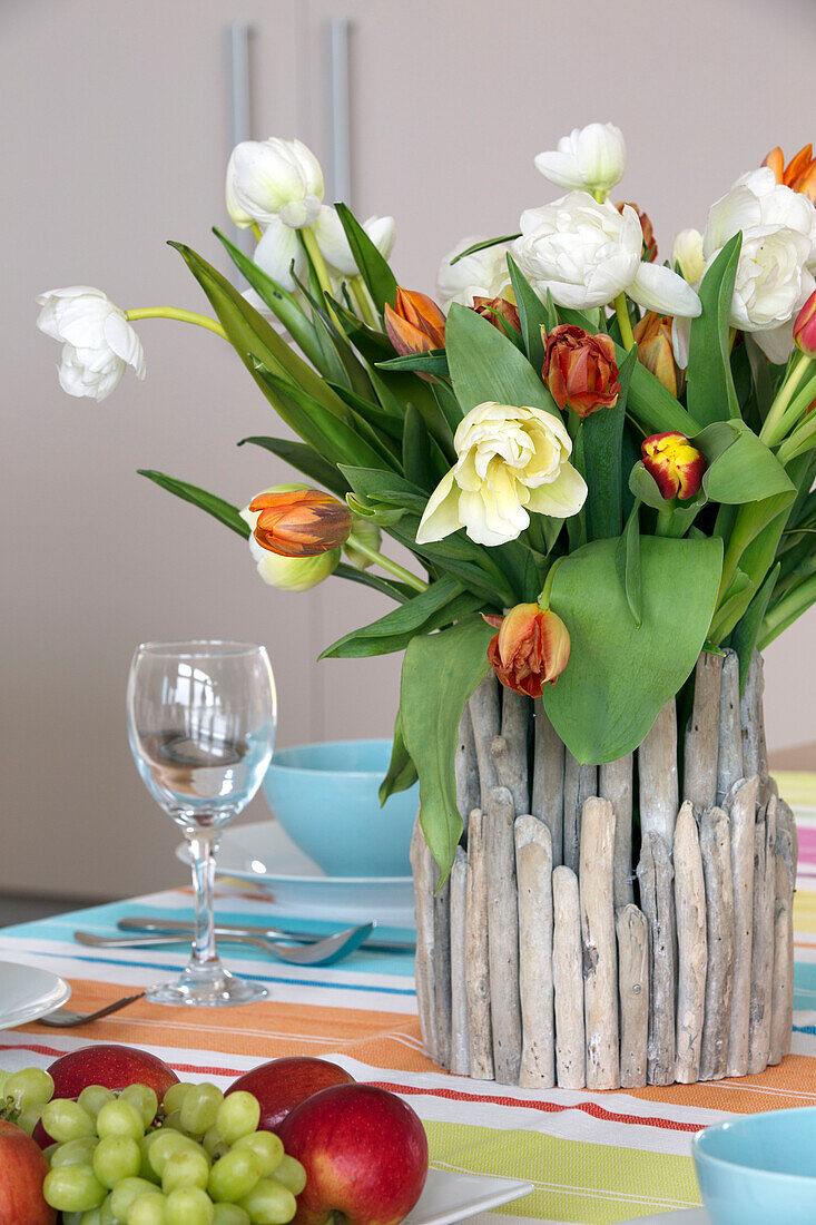 Cut tulip centrepiece on Lechlade dining table Gloucestershire England UK