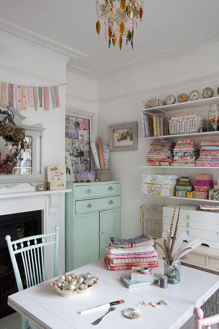 Pastel green sideboard and fabric samples in workroom of Norfolk home England UK